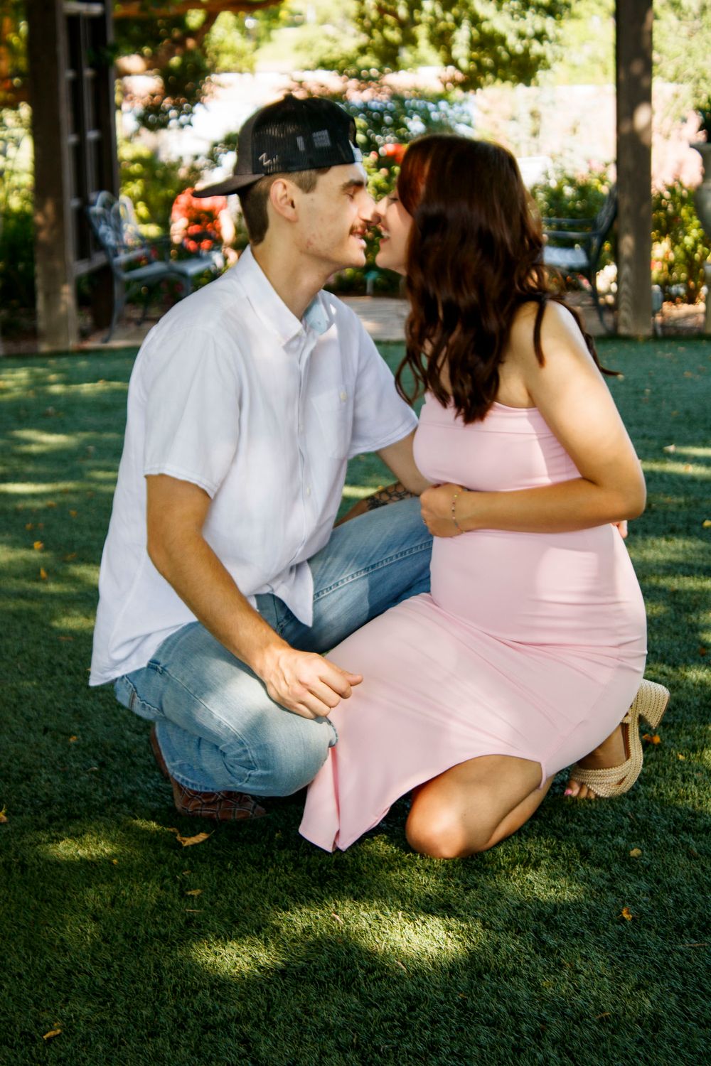 An expecting couple during a maternity photo session at the Botanical Gardens in Amarillo, Texas