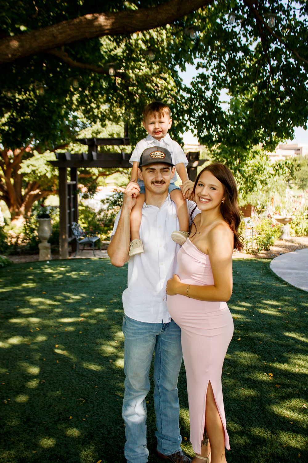 A family of three during a maternity photo session at the Botanical Gardens in Amarillo, Texas
