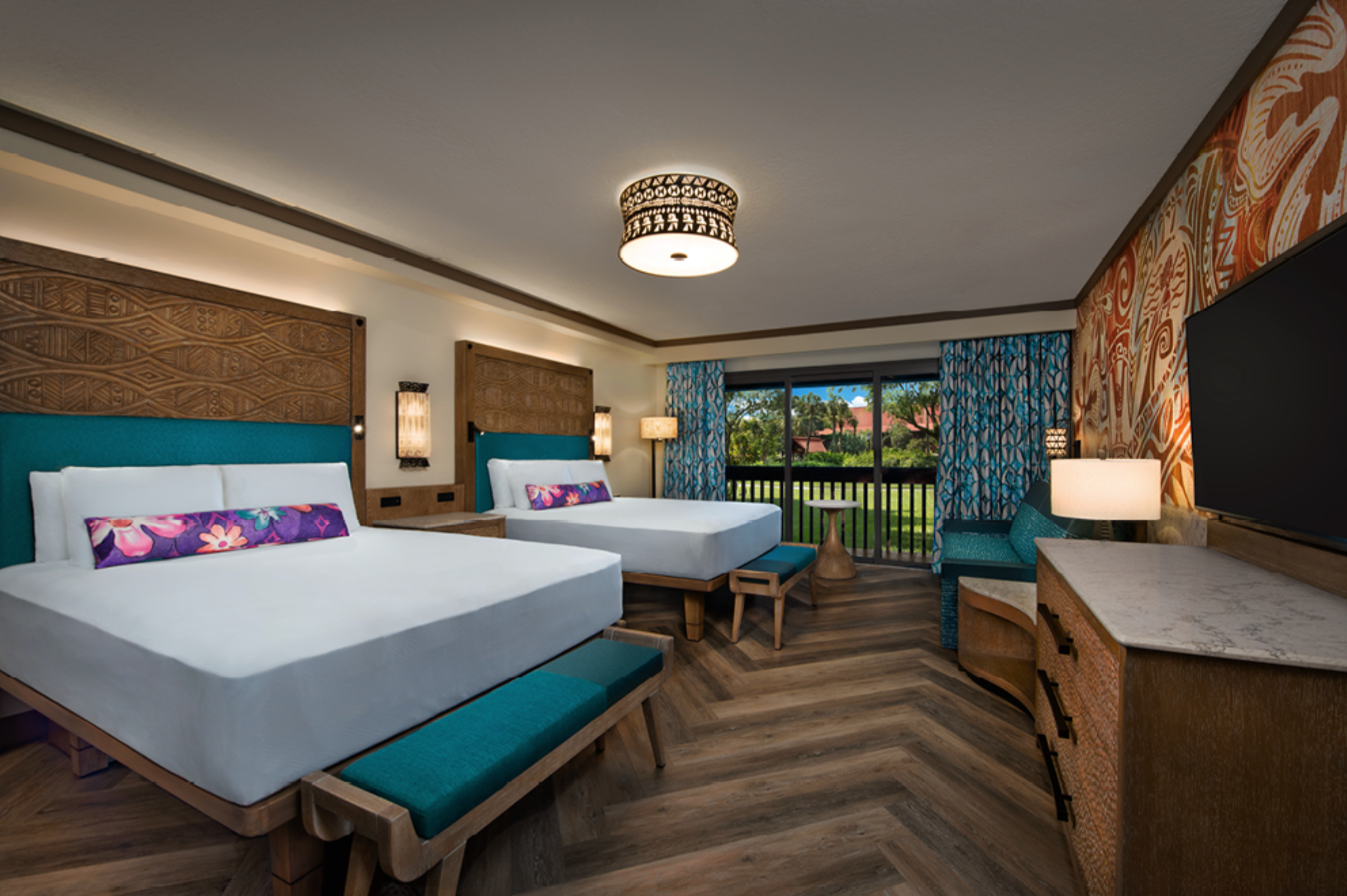 Modern hotel room with two beds featuring teal accents and herringbone wood flooring.