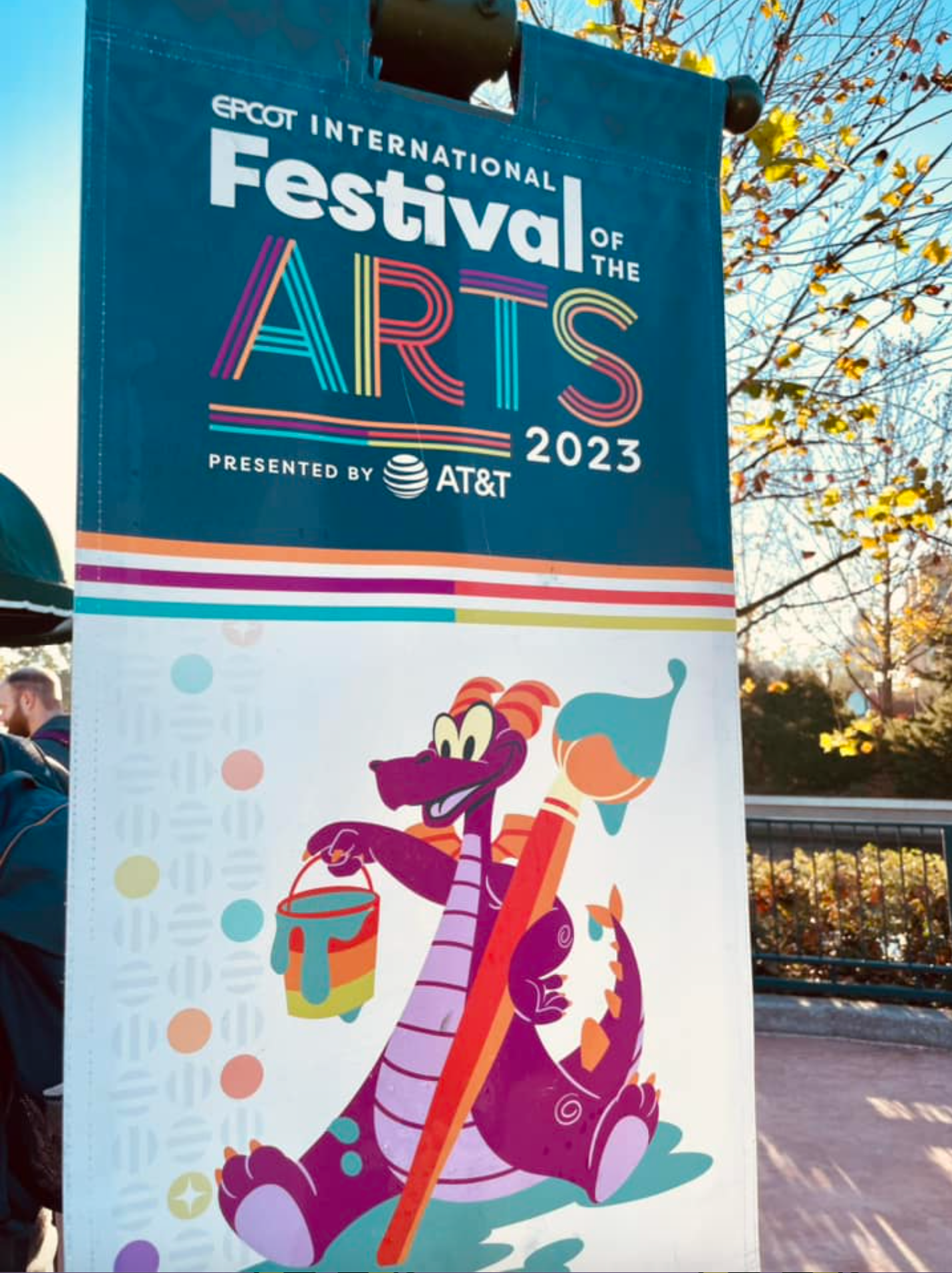 EPCOT Festival of the Arts 2023 sign featuring colorful dragon mascot artwork.