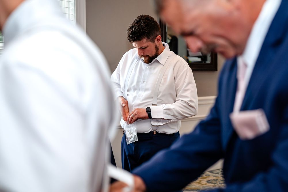Wedding guests in formal attire mingling during a celebration.