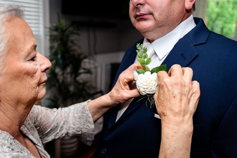 Wedding guests enjoying drinks and conversation at an indoor reception.