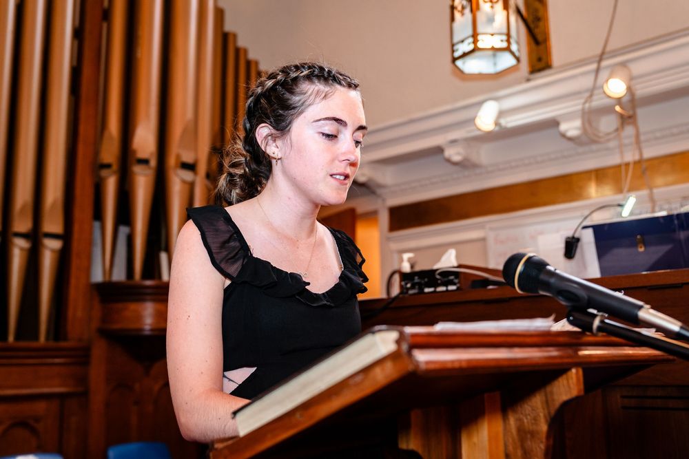 Musical performance during wedding ceremony with piano and vocalist in church setting.
