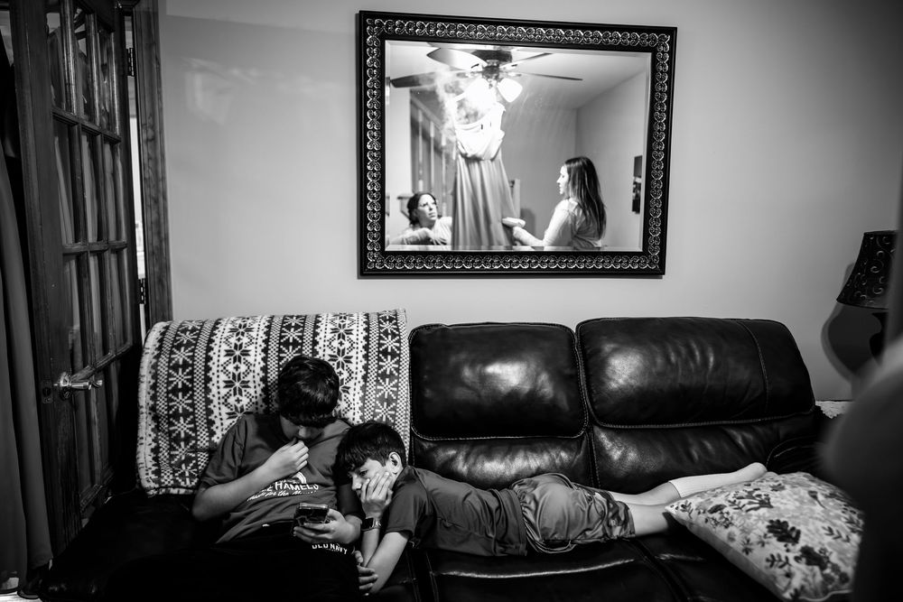 Black and white photo of preparations in a room with dark furniture.