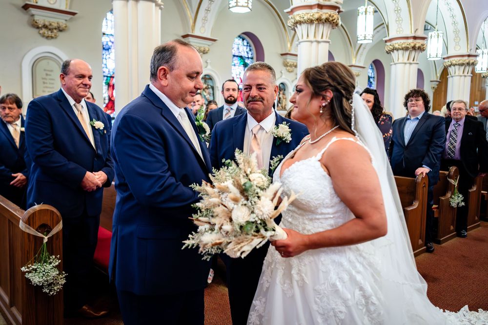 Traditional church wedding ceremony with ornate architecture and filled pews of guests.