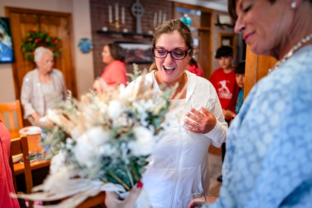 Joyful celebration moments captured during a wedding reception with people laughing and embracing.
