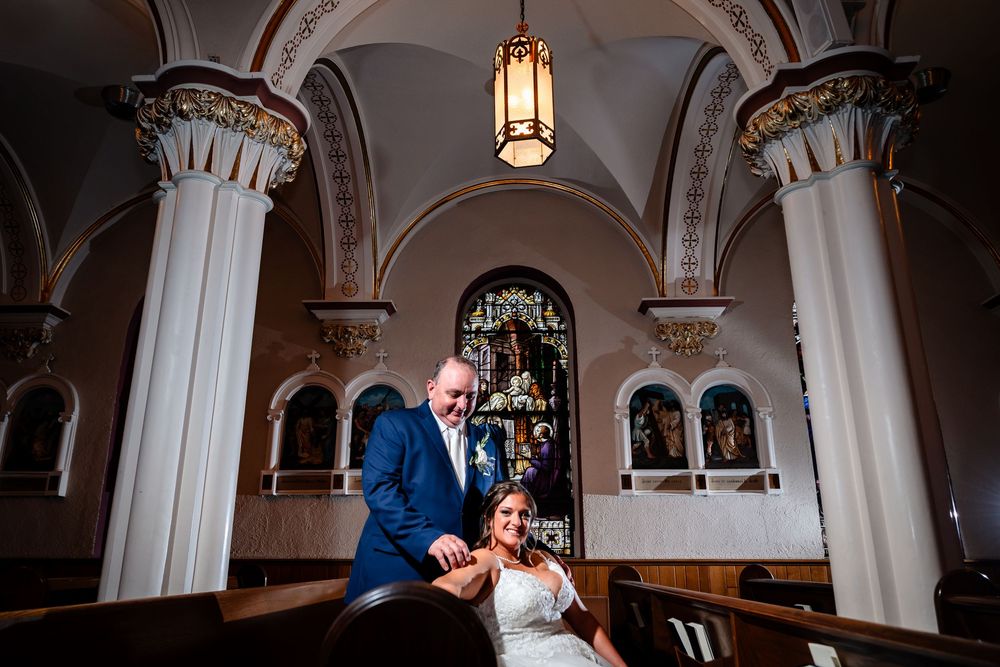 Church sanctuary with vaulted ceilings and hanging pendant lights creating dramatic atmosphere.