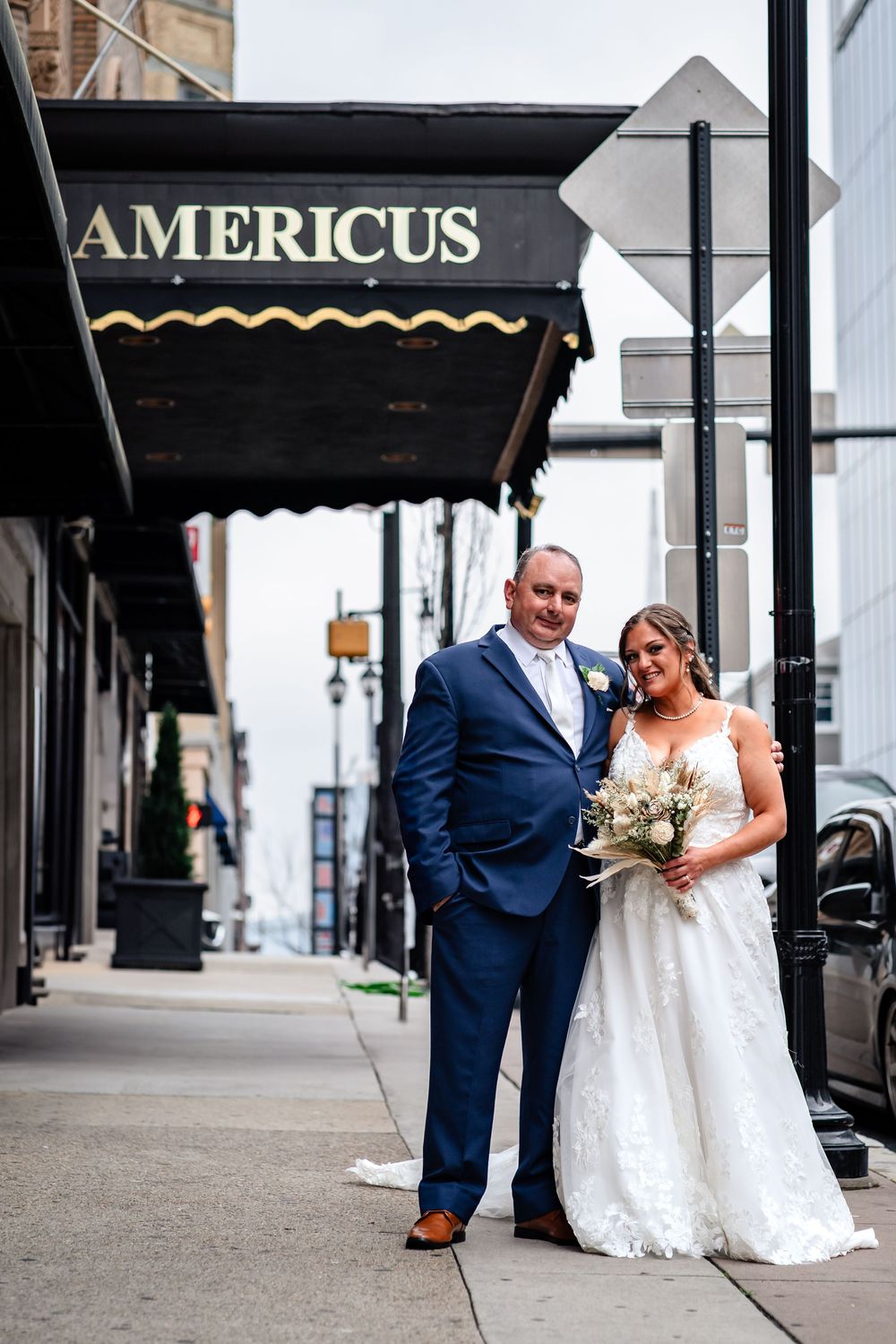 Bride and groom share an intimate moment outside the Americus venue entrance.