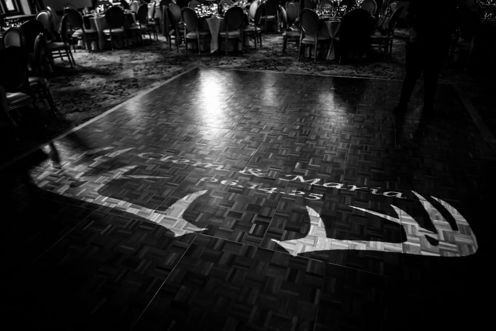 Black and white dance floor shots showing wedding guests in motion.
