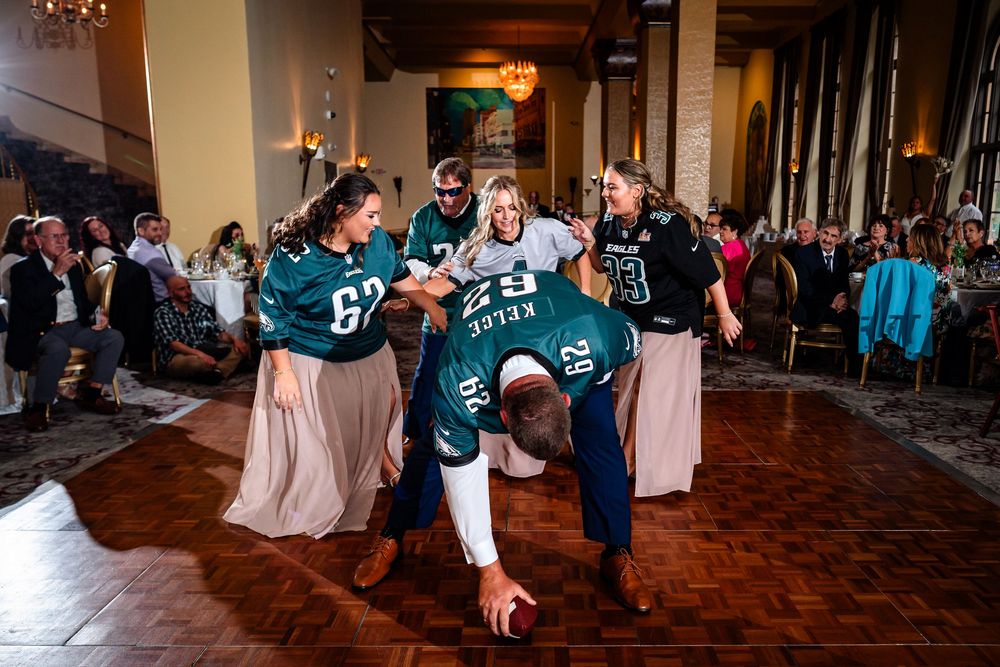 Wide angle view of reception hall with guests dancing and celebrating.