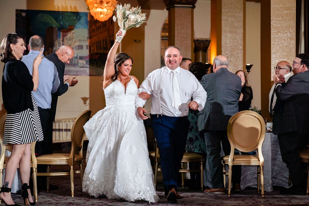 Wedding reception candid moments with guests mingling on dance floor.