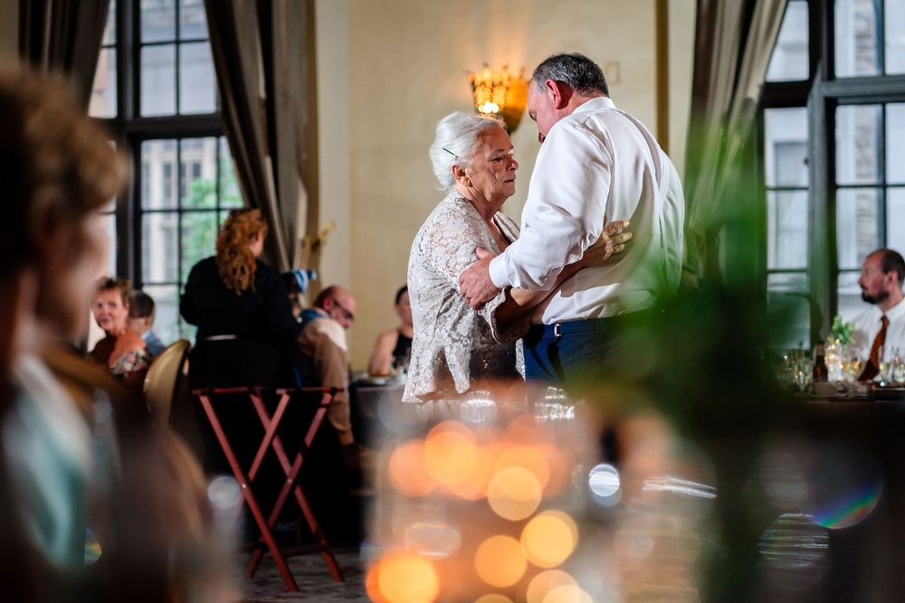 Soft focus wedding reception scene with bokeh lights and decorative elements.