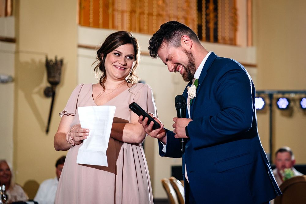 Wedding reception guests share emotional moments during speeches.