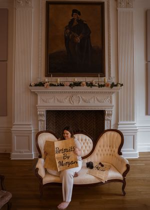 A vintage-style sofa set with white cushions and text writing sits elegantly in a classic room with ornate wall decor.