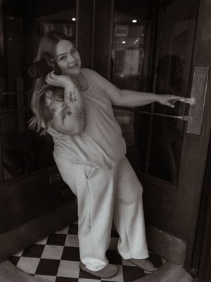 A series of black and white photos showing two people dancing together in an intimate embrace on a checkered floor.