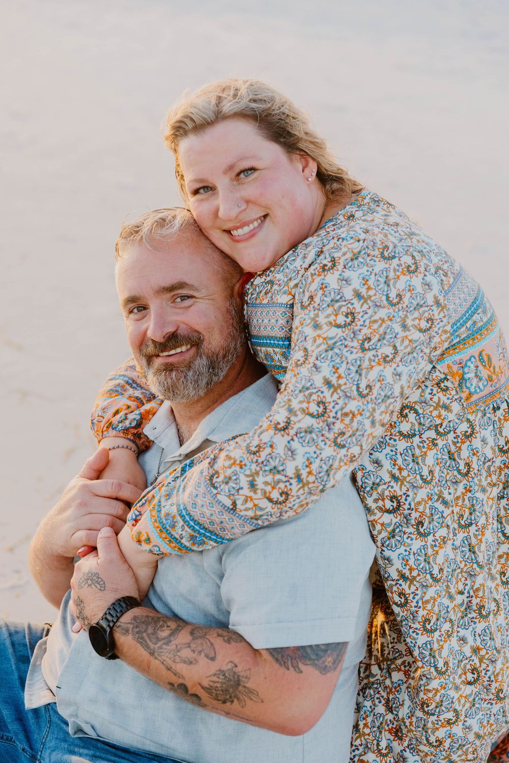 An intimate beach portrait session featuring casual attire and natural expressions.