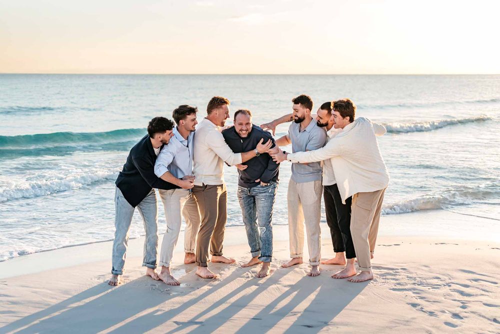 Father and sons portrait photography playing on the beach with blue ocean background