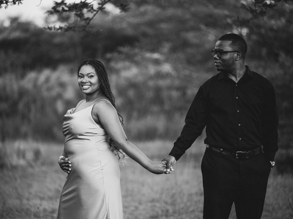 A couple shares an intimate moment together in a scenic outdoor setting.