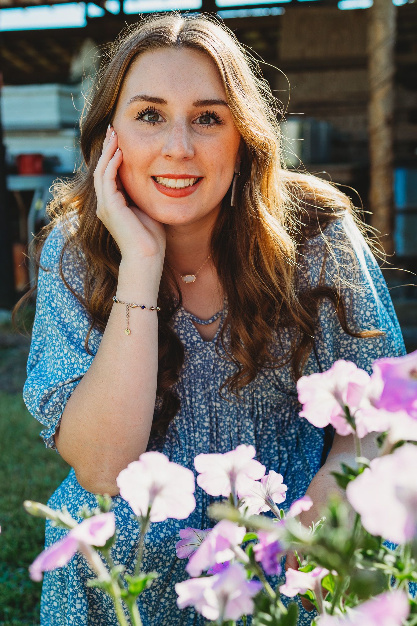Portrait series of woman in blue sequined top posing with purple flowers.