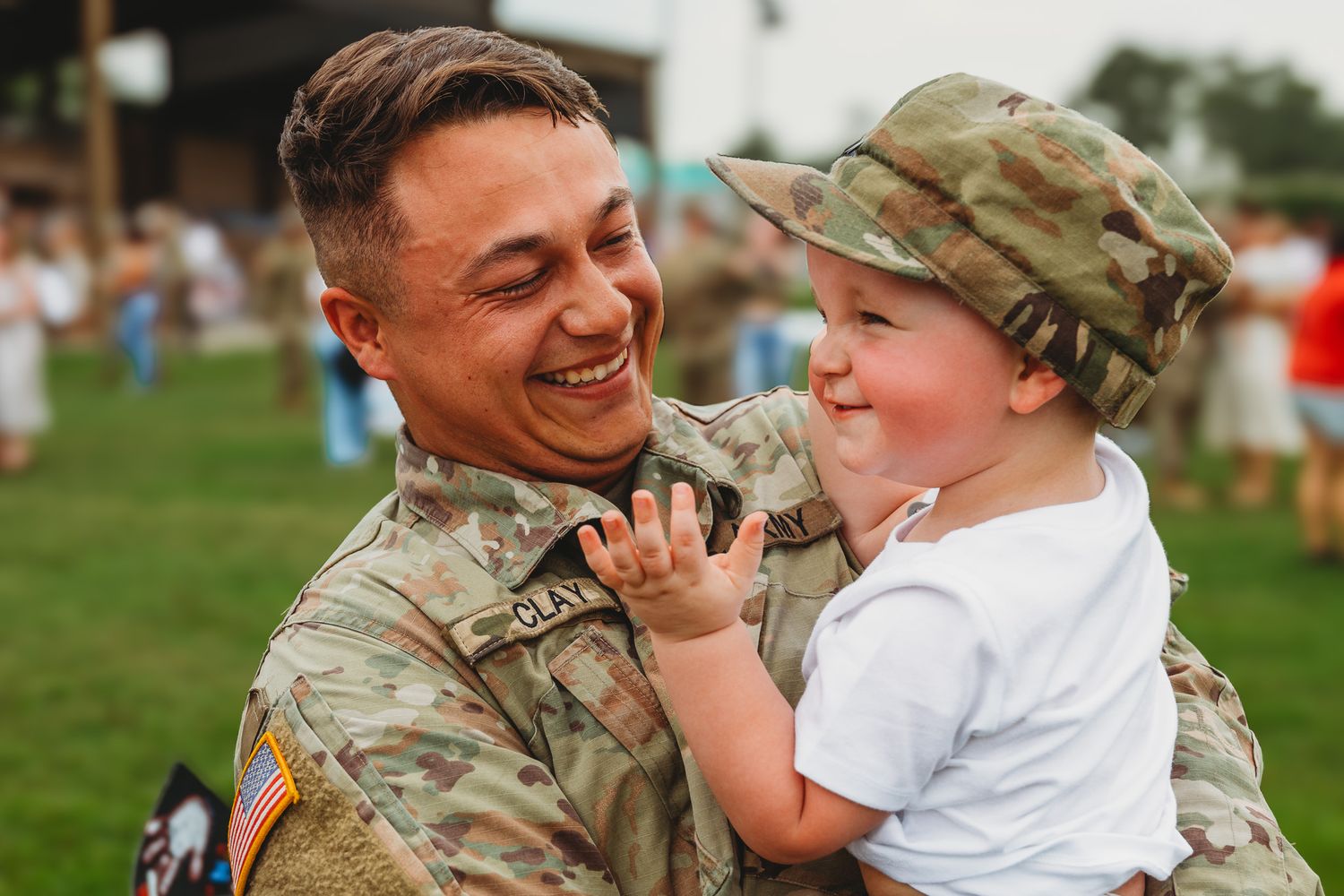 Military service member reunites with loved ones during emotional homecoming ceremony.
