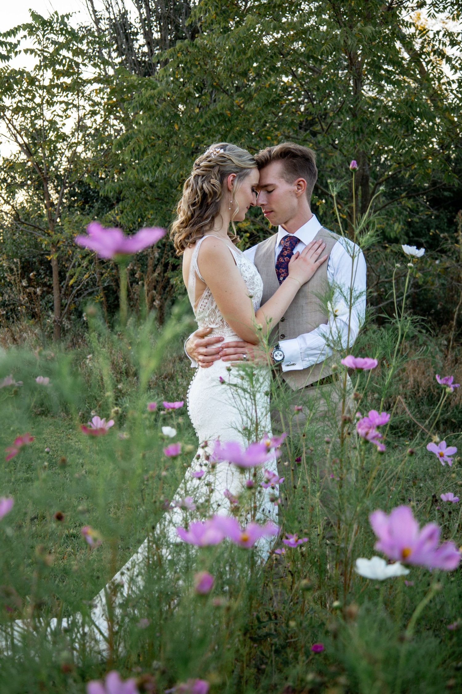 Bride and groom embracing in wild flower field in for lauderdale