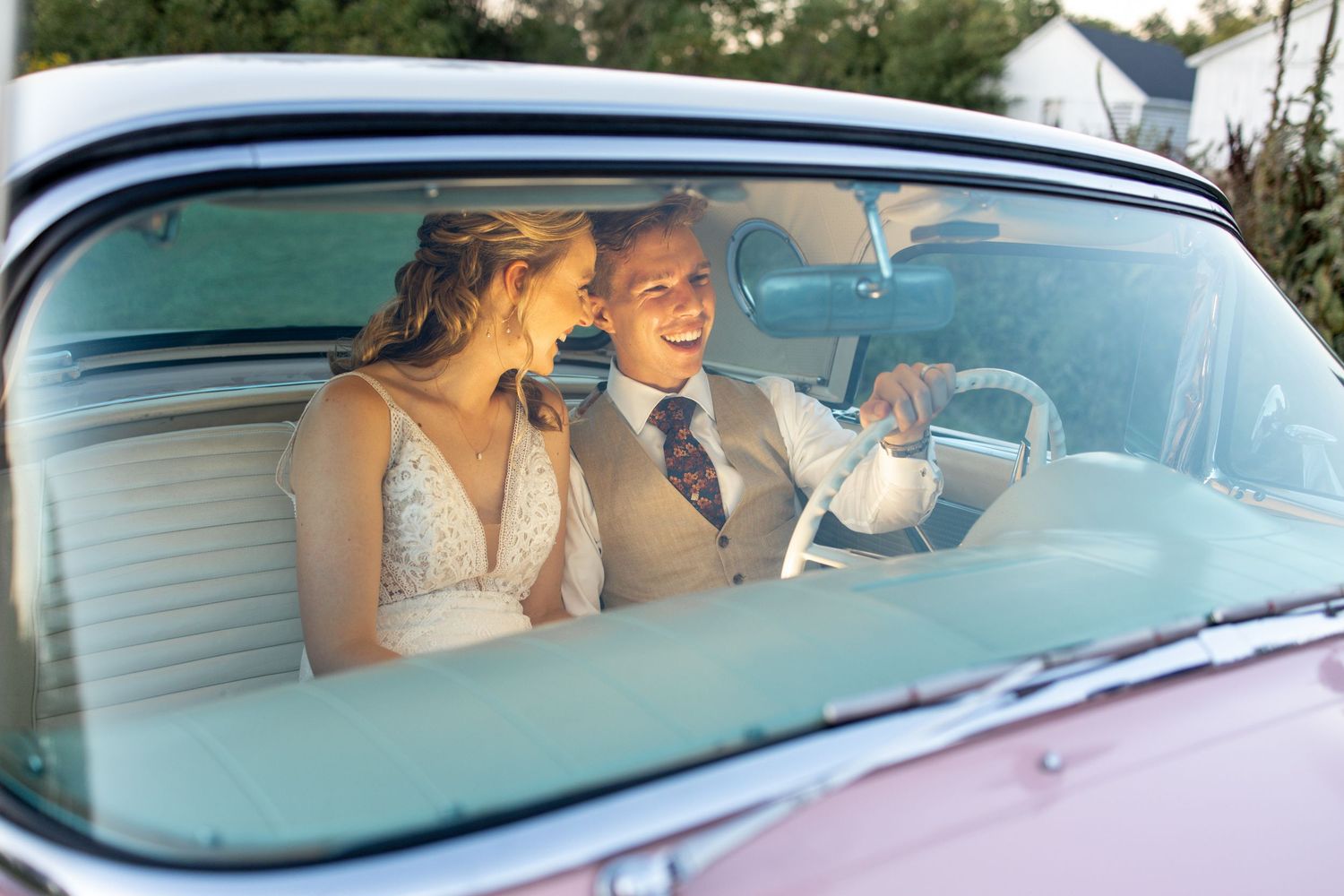 Candid photo of bride in groom inside vintage car in Fort Lauderdale