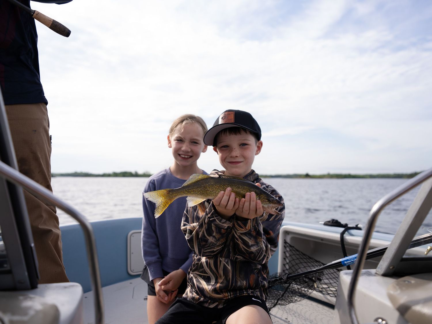 Fishing success on a boat with freshly caught fish on display.