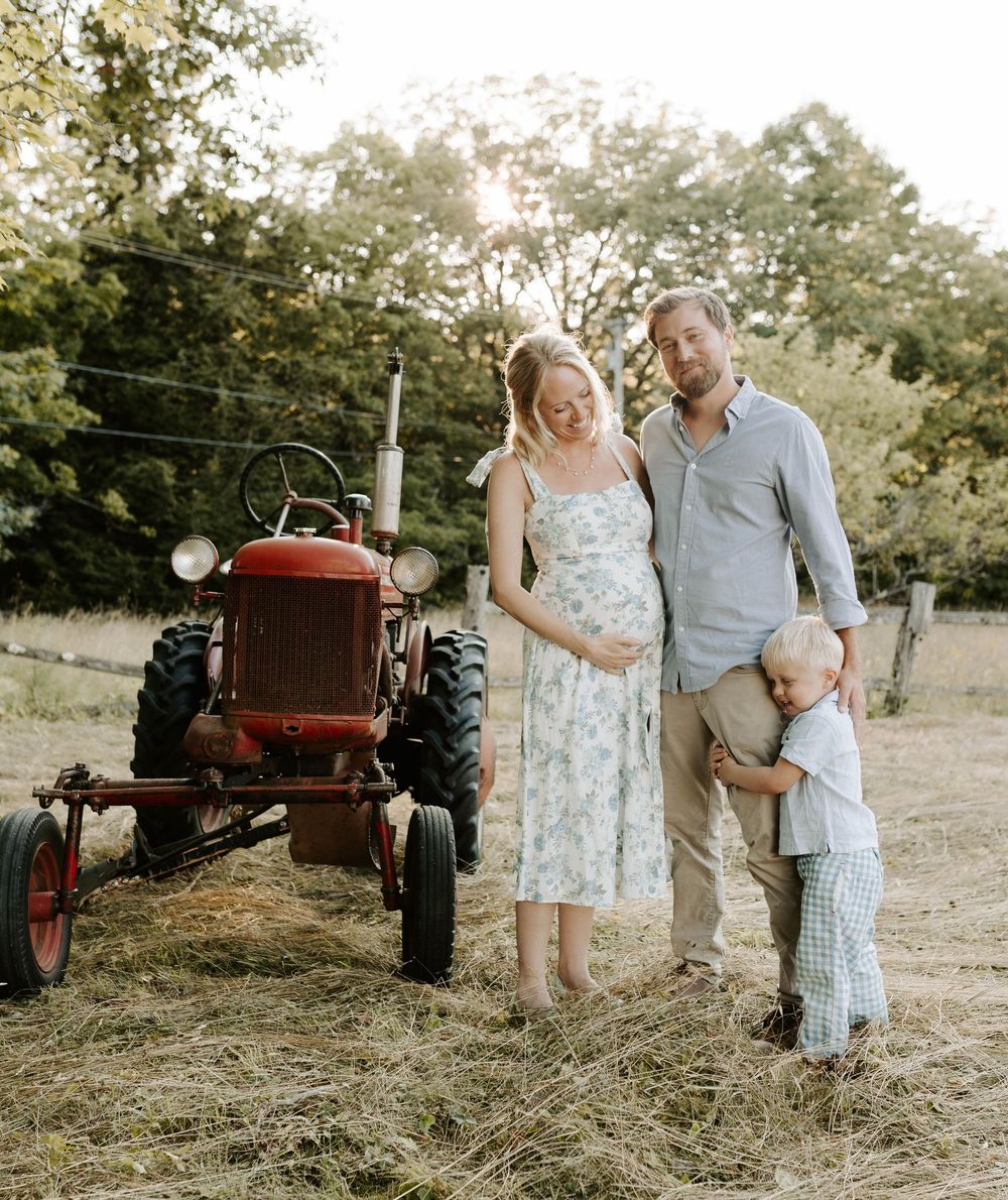 An outdoor couple photographed for a maternity photoshoot.