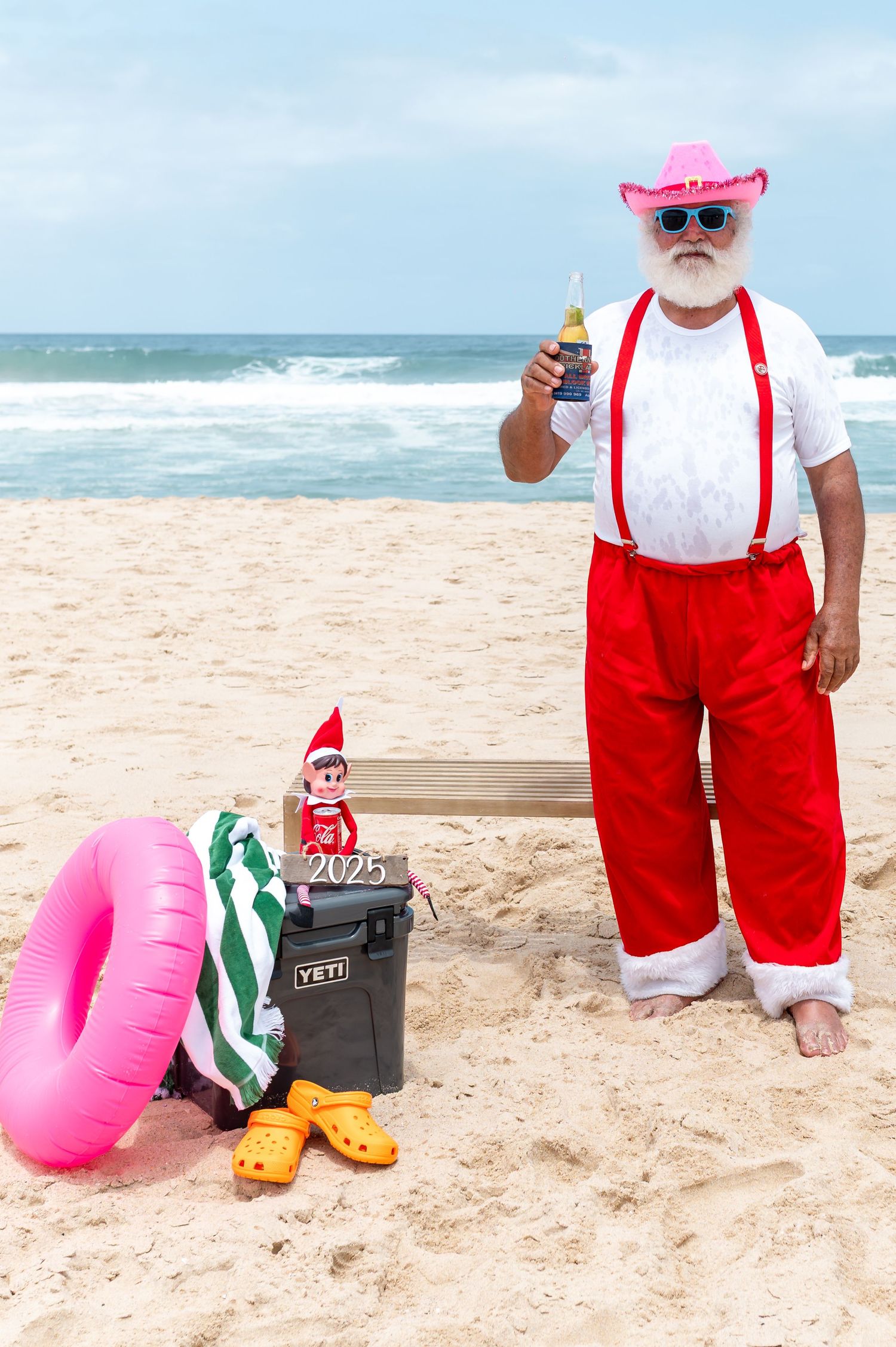 Beachgoers enjoying a sunny day along a sandy coastline with decorative starfish and nautical decor.