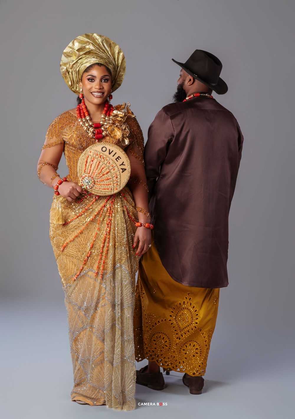 A series of five studio portraits showing a couple in traditional African attire against a gray background.