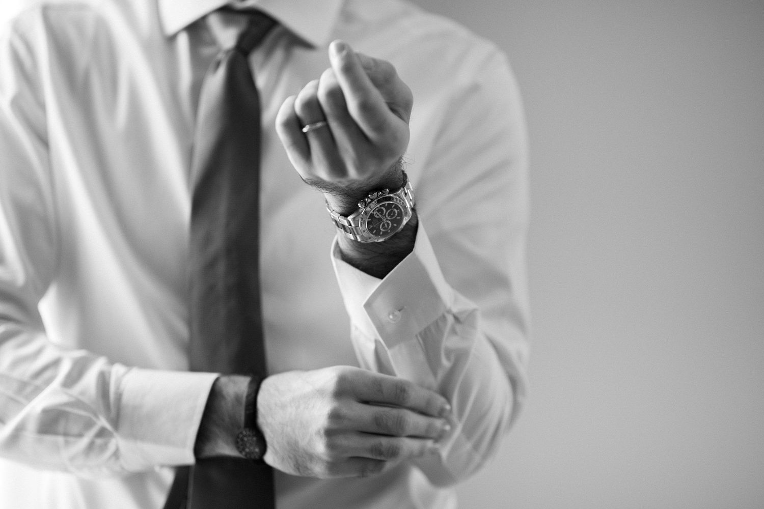 Professional headshots showing formal business attire and crossed arms in black and white.
