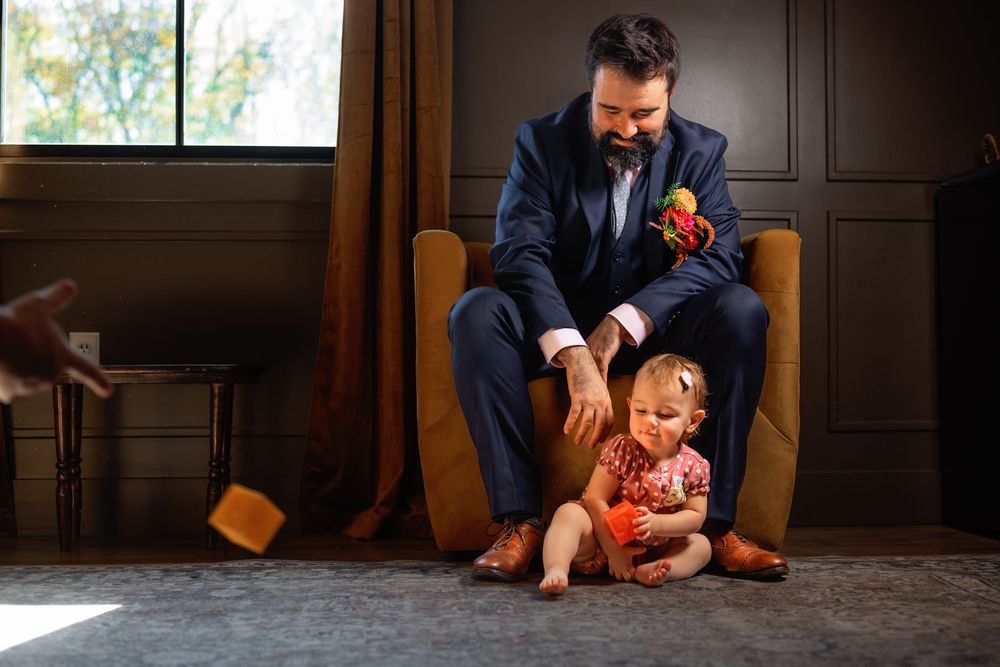 A parent and child sit together on a hardwood floor in a series of candid moments showing their playful connection.