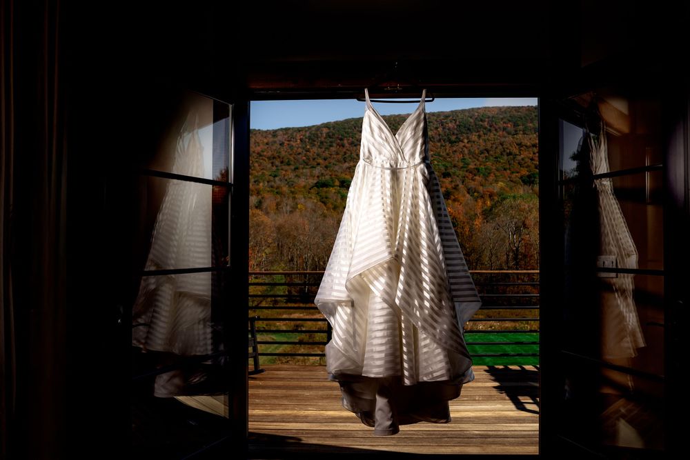 A series of black and white wedding dress photos showing details of lace, fabric, and silhouettes in natural lighting.