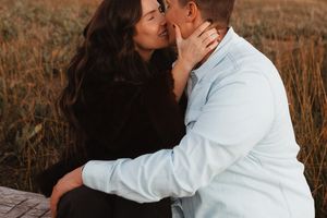 Intimate moment captured between couple in natural outdoor setting.