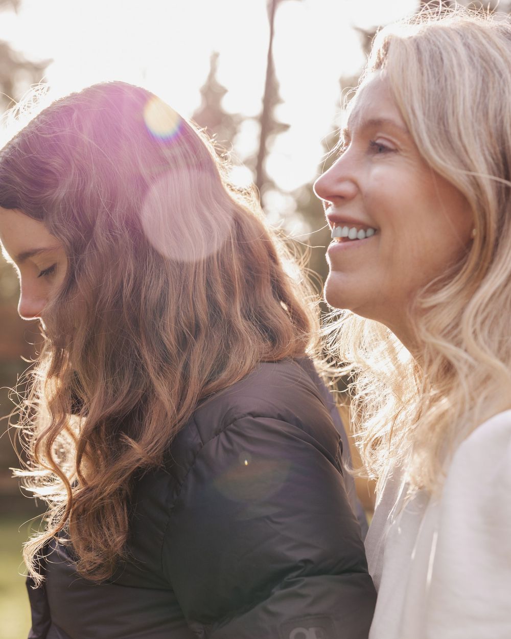 A sequence of candid profile shots showing a person with blonde hair laughing and smiling in natural sunlight.