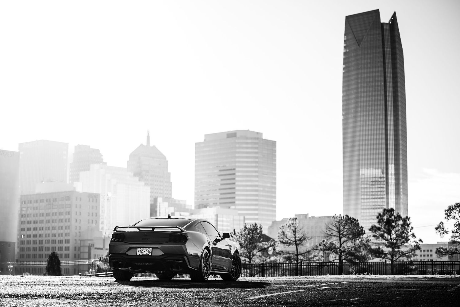 Black and white cityscape showing modern skyscrapers and office buildings against a bright sky in Oklahoma City.