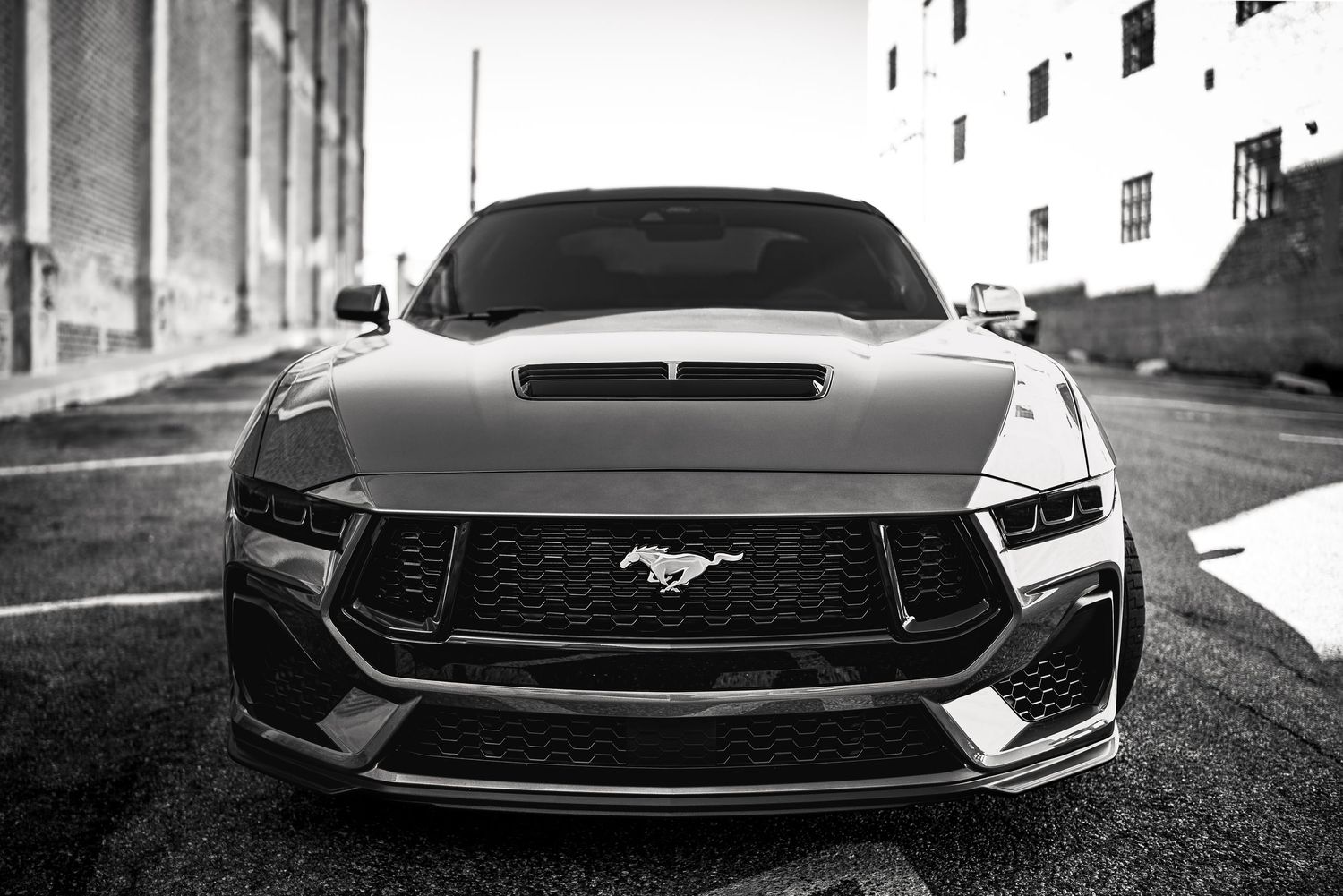 A sequence of black and white photographs showing different angles of a Ford Mustang's front grille and headlights.