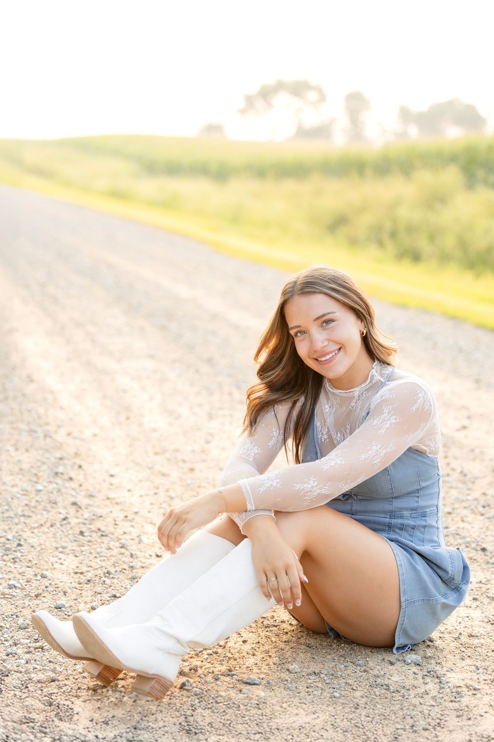 Casual outdoor portraits on a Iowa dirt path during golden hour wearing denim and white lace.