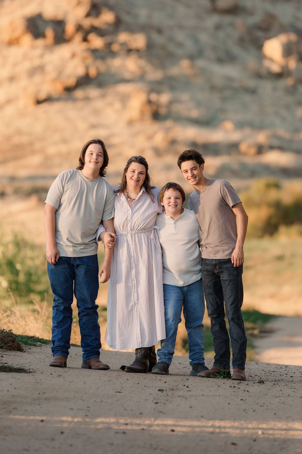 Progressive family photo sequence showing playful interactions in a desert landscape.