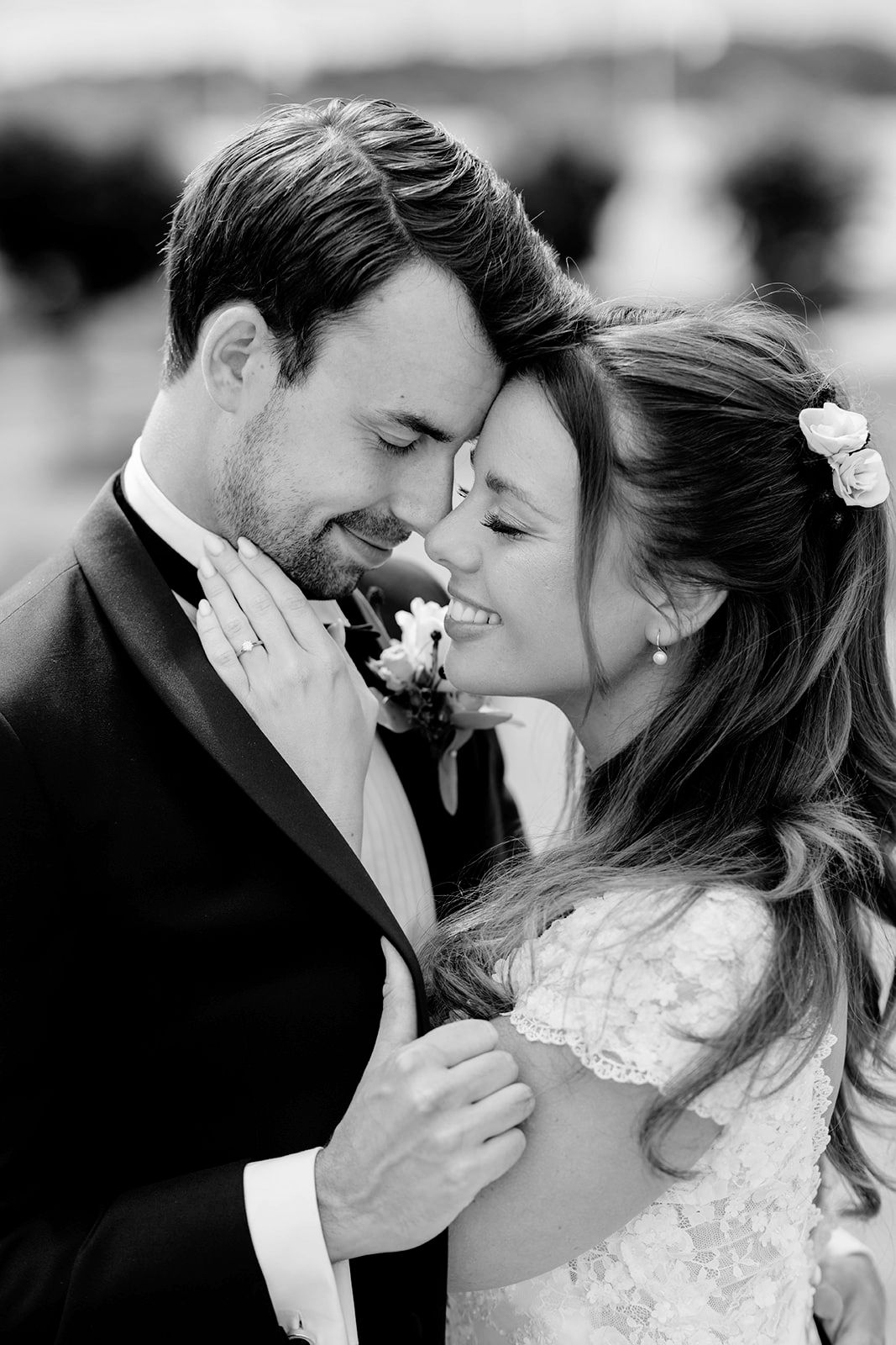 A romantic black and white photo series showing tender moments between a couple on their wedding day.