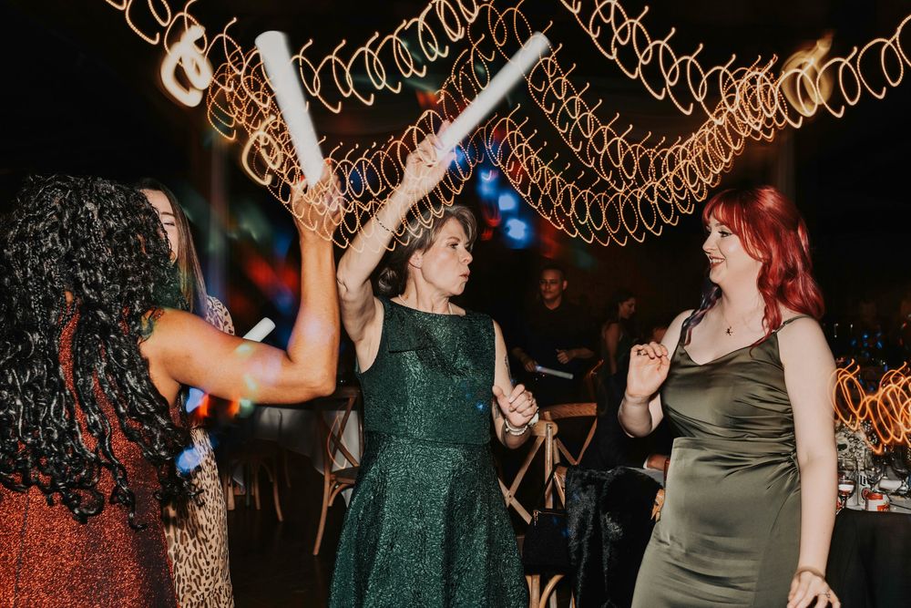 Candid late-night dance floor moment with guests celebrating in an energetic party atmosphere.
