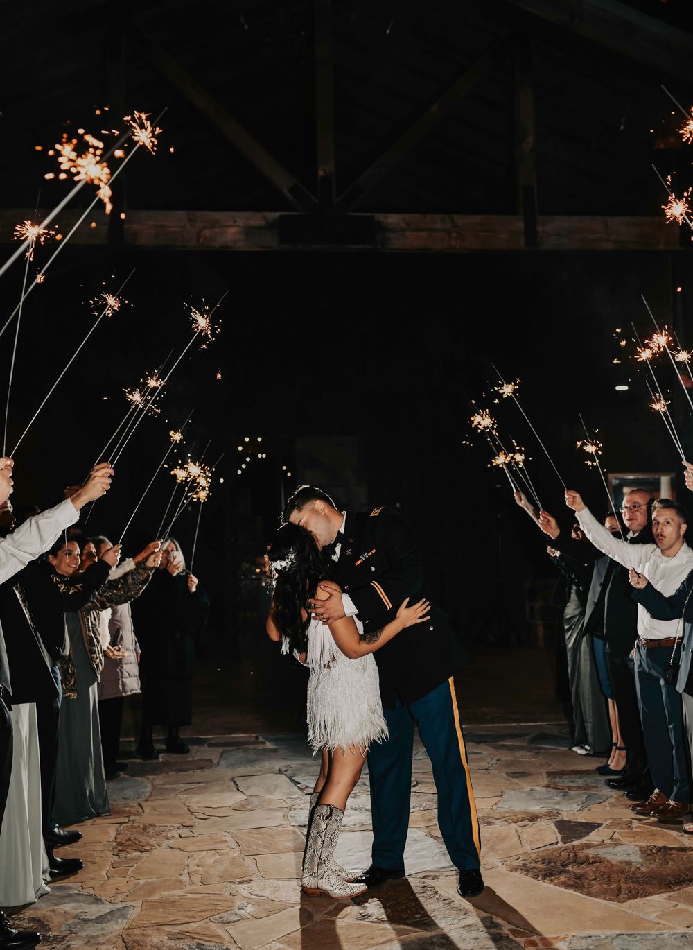 Bride twirling in sparkler light as the couple exits their reception.