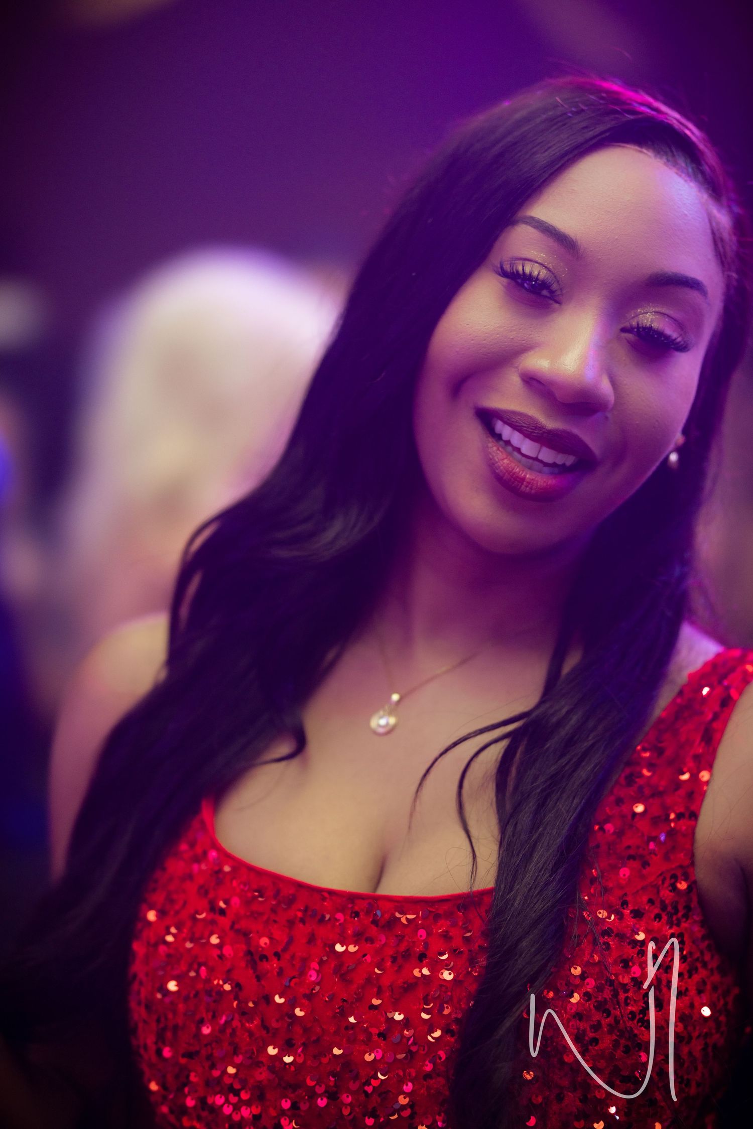 A sequence of photos showing someone in a sparkly red dress against a purple-tinted background.