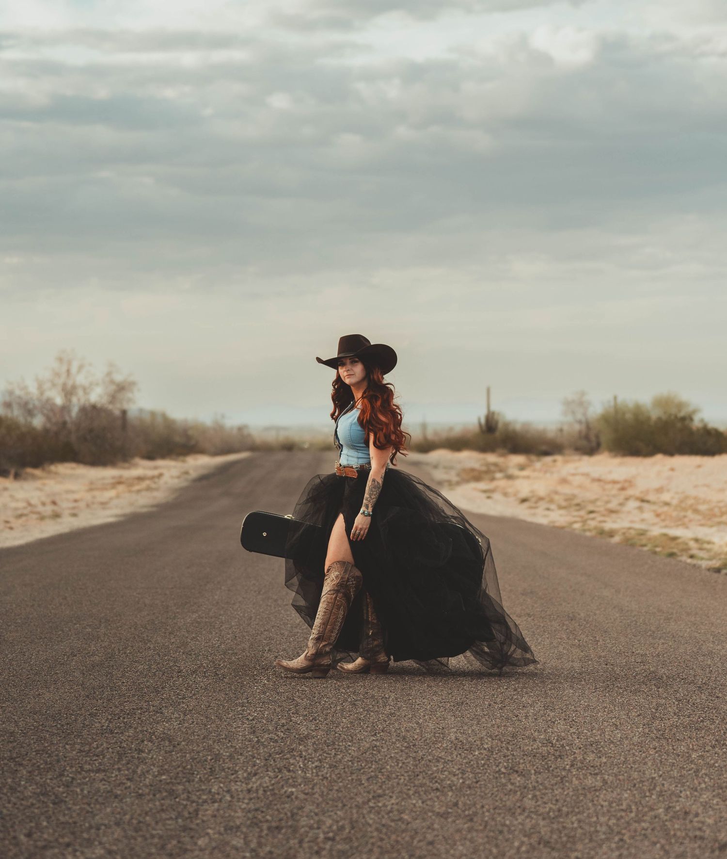 Palomino Quarter horse and Cowgirl in blue dress sharing tender moment in grassy field at dusk.