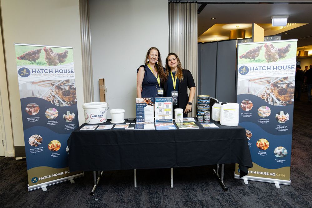 Professional conference setup with banners and displays showing branding materials in a corporate event space.