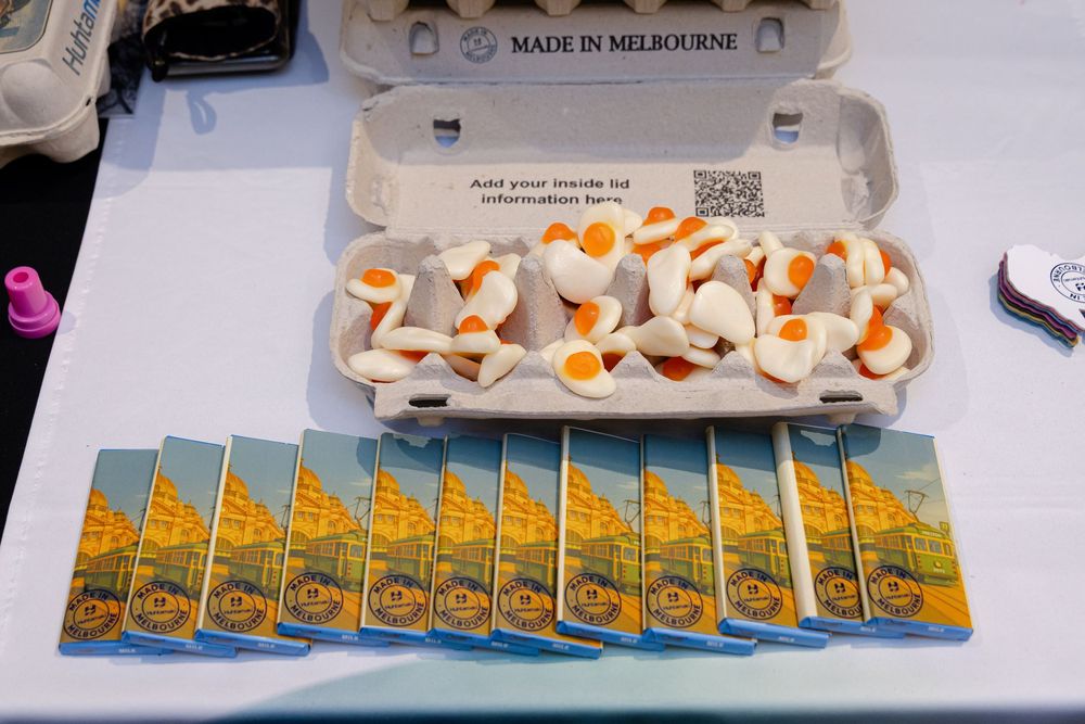 A row of yellow promotional items or branded merchandise arranged neatly on a display surface. Kirsten Graham Photoraphy
