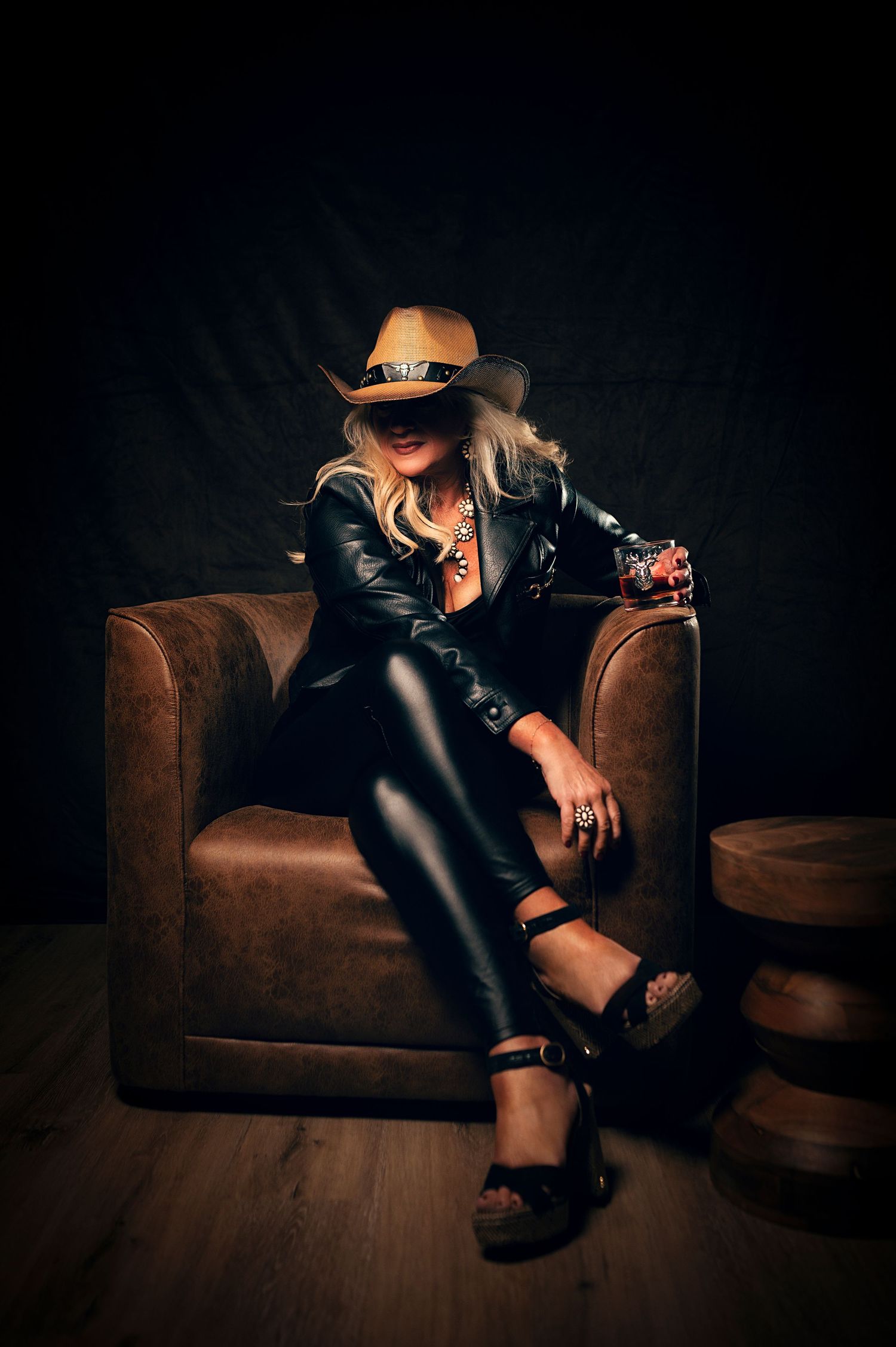Woman in a Leather outfit and cowgirl hat for a 40 over 40 photoshoot in Utah, Creative portraits photographed by Carl James Photography.