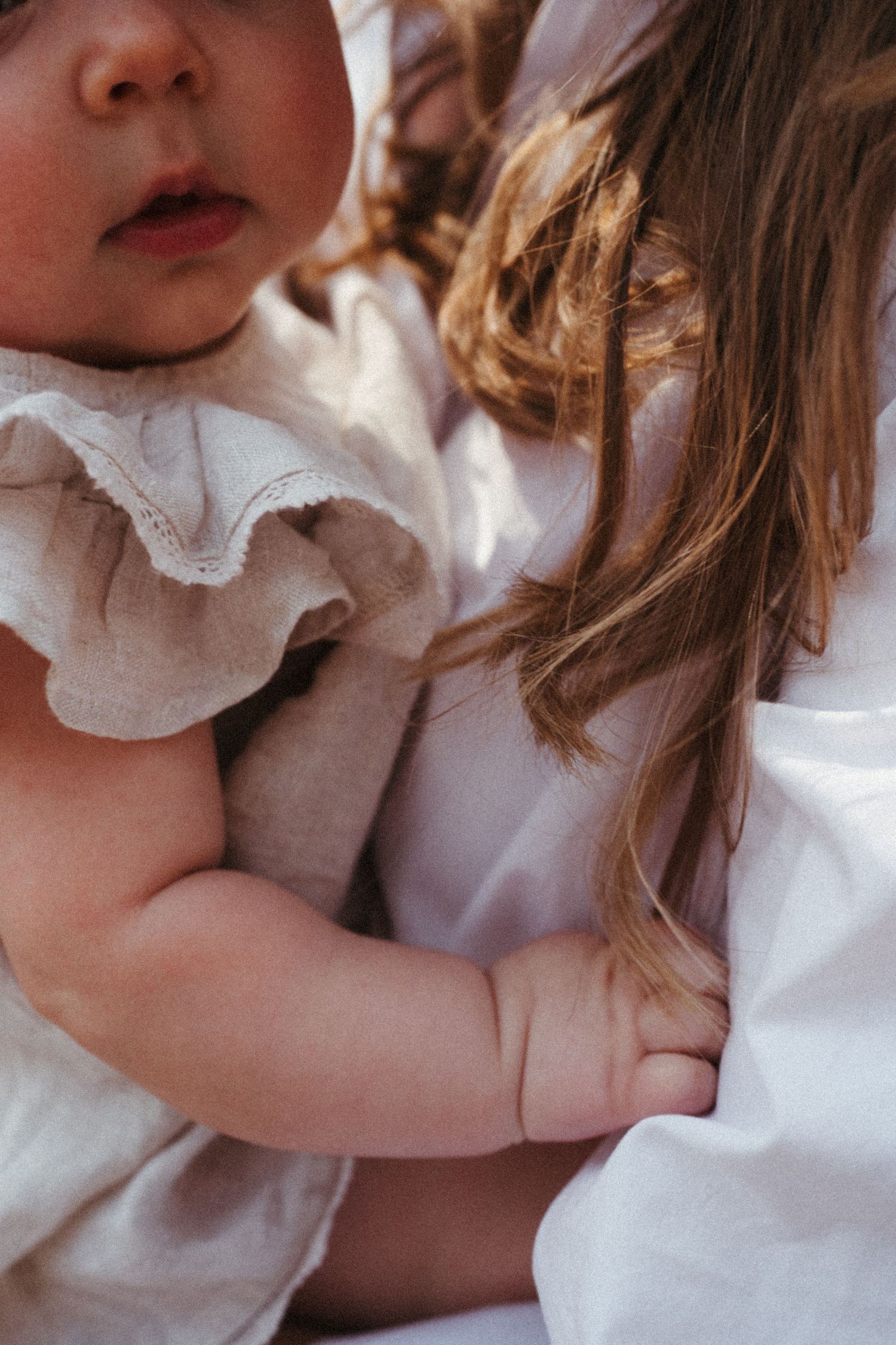 Close up of gentle maternal bonding moment in soft lighting.