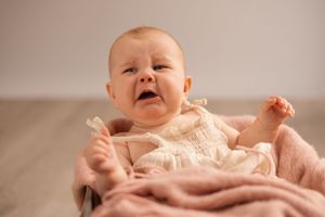 6 month toddler crying during newborn session at Bishopdale studio Christchurch , natural light