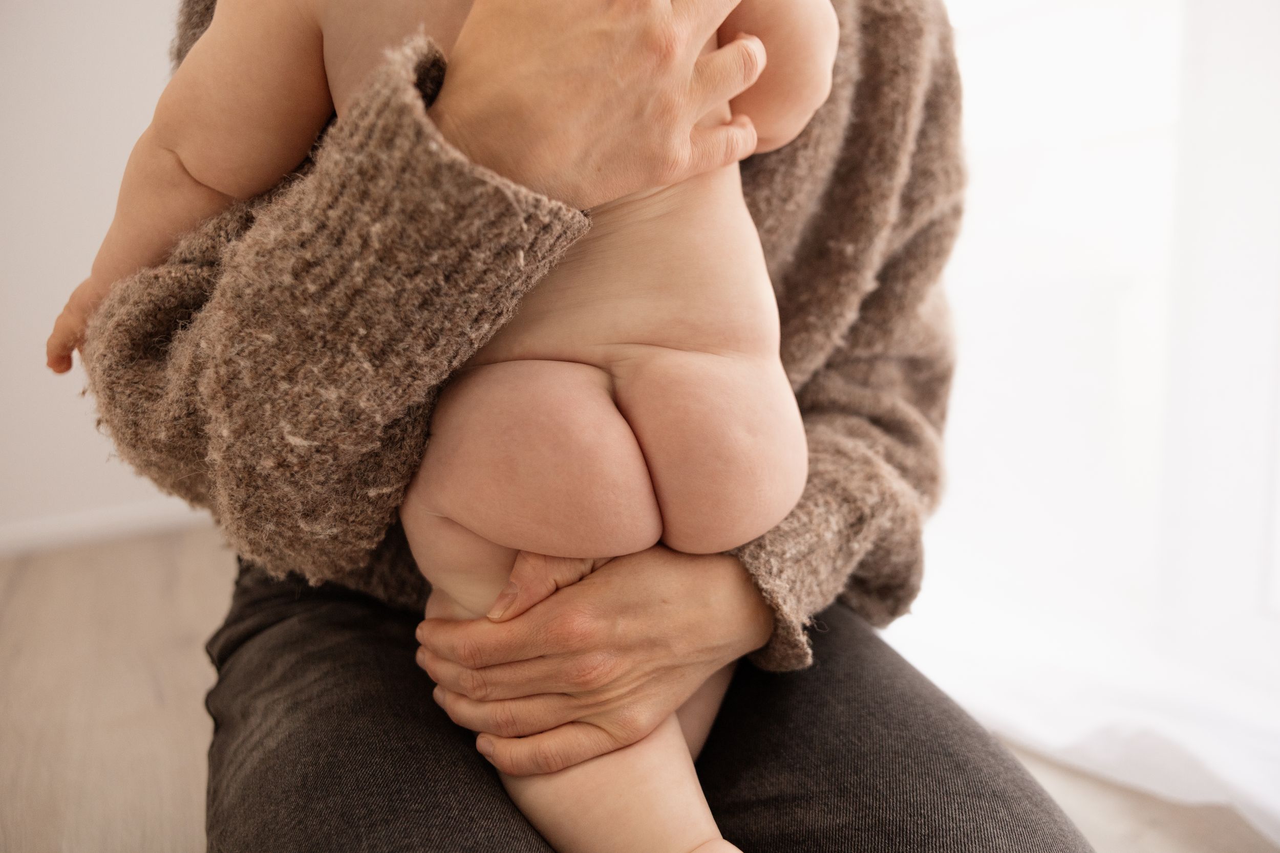 Milestone session in the Bishopdale studio, christchurch. Mum holding baby